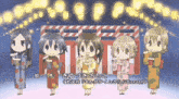 a group of girls in kimonos are standing in front of a stage with lanterns in the background