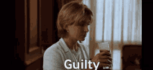 a woman is holding a glass of beer and the word guilty is above her