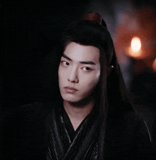 a close up of a man with his eyes closed in a dark room