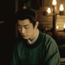 a man with a crown on his head looks down at something