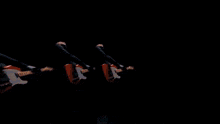 a man playing a guitar in a dark room with a blue light behind him