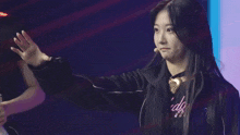 a woman wearing a black jacket and a t-shirt that says i do
