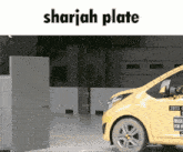 a picture of a yellow car with the words sharjah plate on it