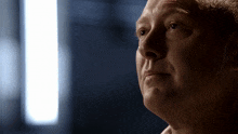 a close up of a man 's face in the dark