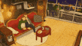 a man is sitting on a couch in a living room next to a coffee table .