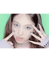 a close up of a woman 's face with a choker and rings on her fingers