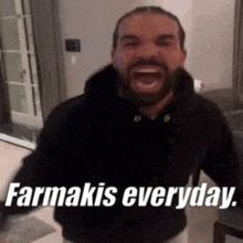 a man with a beard is standing in a living room with his mouth open and says farmakis everyday .