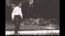 a black and white photo of a man in a white shirt