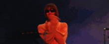 a man in a white shirt is dancing on a stage in front of a sign that says dw-n-k