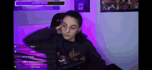 a girl wearing glasses is sitting in front of a microphone with a star wars poster on the wall behind her