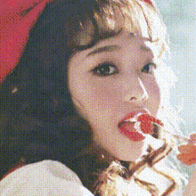 a woman in a red hat is eating a strawberry with a lollipop .