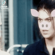 a woman with pig ears on her face is looking at the camera