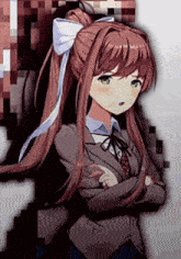 a girl with long brown hair and green eyes is standing with her arms crossed and a bow in her hair .