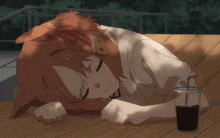 a girl with the letter b on her head is sleeping on a wooden table