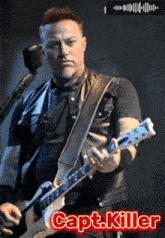 a man is playing a guitar in front of a microphone with the name capt.killer on the bottom