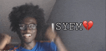a young man wearing glasses and a blue shirt with syfm written on the bottom