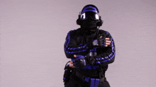 a man wearing a mask and headphones is wearing a blue and black outfit