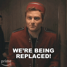 a man in a red jacket and hat says we 're being replaced
