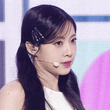 a close up of a woman 's face with a microphone
