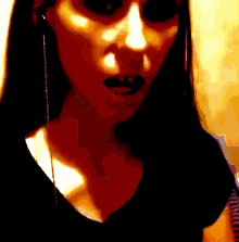 a close up of a woman 's face with black lips
