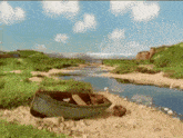 a boat sits on the shore of a river with mountains in the background