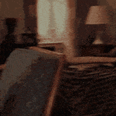 a blurry picture of a person sitting in a chair with a stack of books in the background