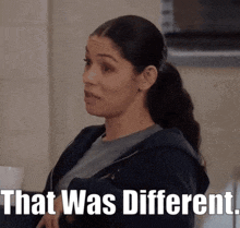 a woman in a ponytail is sitting in front of a sign that says " that was different "