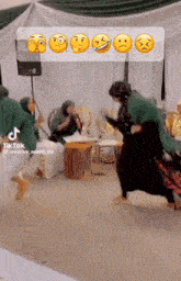 a tiktok video of a group of people dancing with emojis on the screen