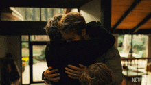 hugging each other adam young adam louis reed ryan reynolds