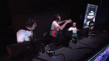two men celebrate in front of a screen that says " miami "