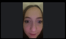 a close up of a woman 's face with a blurred background