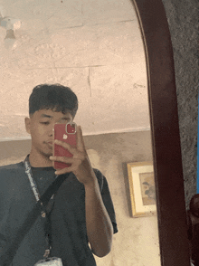 a young man taking a selfie with an apple iphone