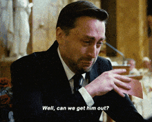 a man in a suit and tie is crying and says " well can we get him out "