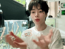a young man wearing a white t-shirt that says " i love you "