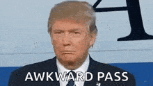 donald trump is wearing a suit and tie and is making an awkward pass face .