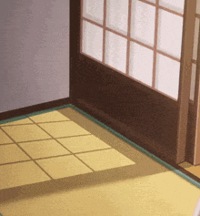 a room with a sliding glass door and a yellow rug on the floor