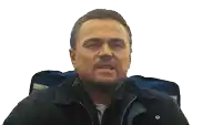 a man in a jacket and tie wipes his face with a napkin