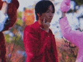 a man in a red jacket is making a funny face