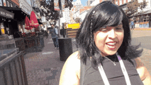 a woman stands in front of a building that says beer-cocktails