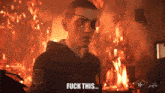 a man with a patch on his eye says fuck this in front of a fire