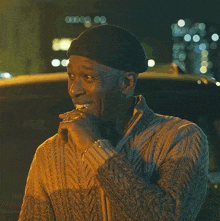 a man wearing a beanie and sweater says it 's disturbing on the screen