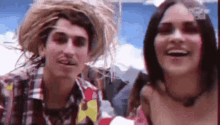 a man and a woman are standing next to each other and smiling .