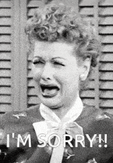 a black and white photo of a woman crying with the words i 'm sorry written below her