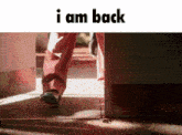 a picture of a person walking with the words " i am back " below them