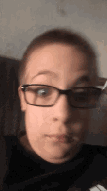 a close up of a person 's face with glasses