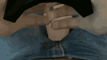 a close up of a person 's stomach with a black object in the background