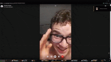 a computer screen shows a man with glasses on a call