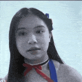 a black and white photo of a girl with a red bow on her head