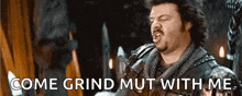 a man in a knight 's armor is yelling and says come grind mut with me .