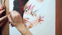 a person is painting a portrait of a young boy with colored pencils